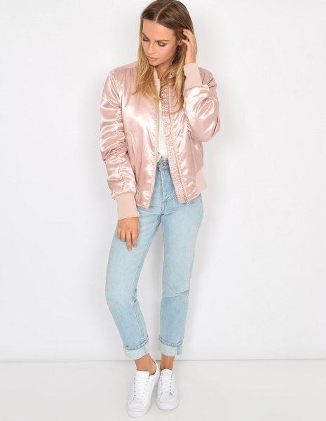Light pink satin bomber jacket worn with a white shirt and light blue jeans