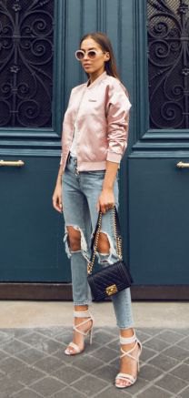 Light pink satin bomber jacket with heavily ripped cropped jeans