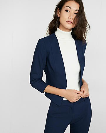 Dark blue slim fit blazer with white sweater and faux neckline