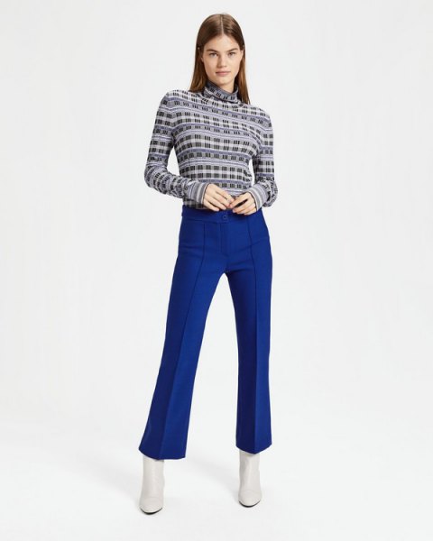 black printed turtleneck sweater and blue flared pants