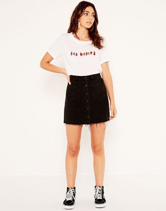 T-shirt with white print and denim skirt with black button on the front