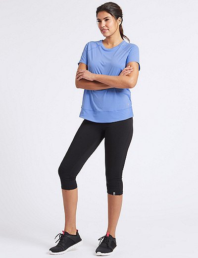 light blue t-shirt with black short leggings and sneakers