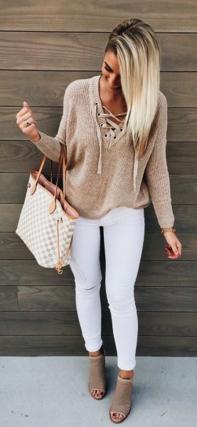 Light brown lace-up sweater with white skinny jeans