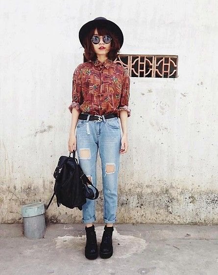 brown printed vintage button-down shirt and high-waisted ripped jeans