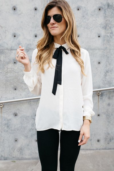 white and black tie-neck chiffon shirt and skinny jeans
