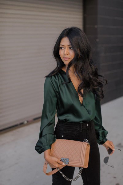 Emerald green long sleeve silk top with black skinny jeans