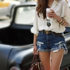 white loose fitting linen shirt with ripped blue jean shorts