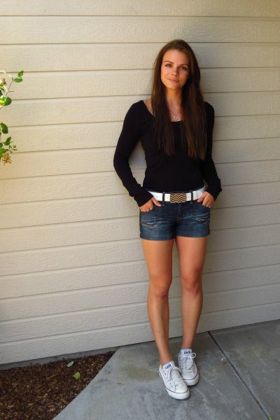 black form-fitting sweater with denim shorts and white belt