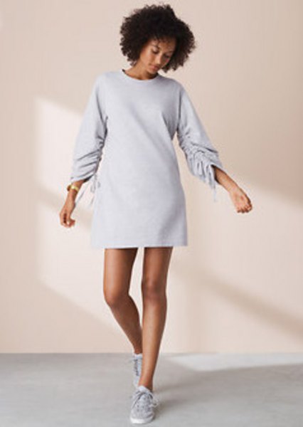 Long sleeve mini sweatshirt dress with crew neck and low top sneakers