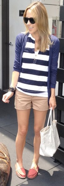 beige khaki shorts with a dark blue and white striped polo shirt