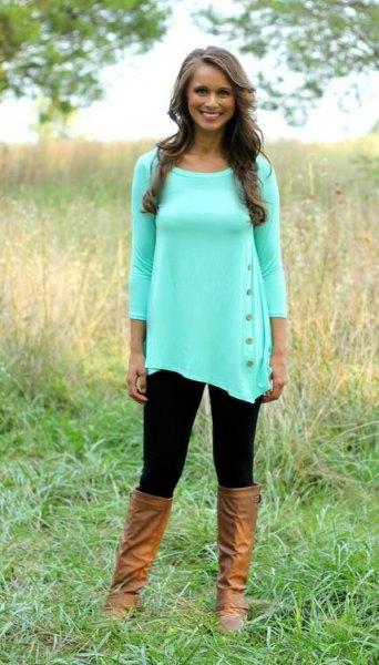 white tunic blouse with three-quarter sleeves and knee-high leather boots