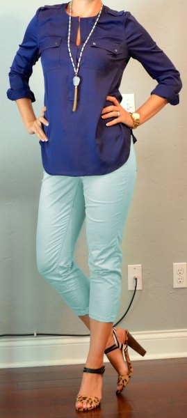 Dark blue long sleeve keyhole blouse with white cropped trousers