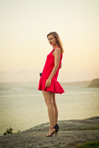 red sleeveless fishtail mini dress with black heels