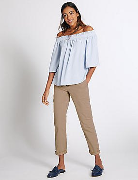 Light blue strapless blouse with beige, slim-fitting chinos