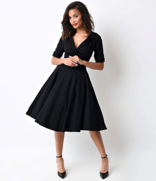 black swing dress with deep V-neckline and half sleeves