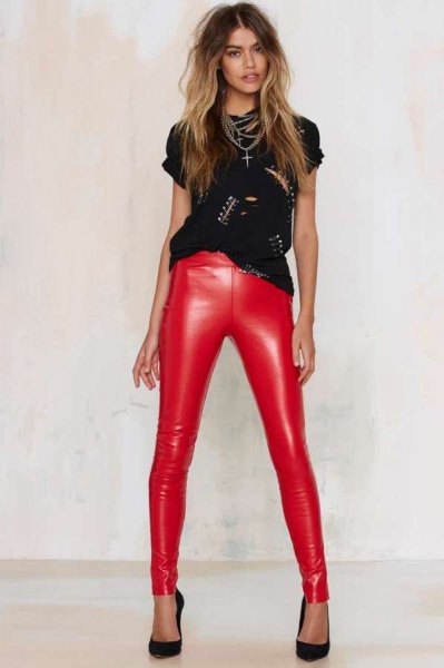 black t-shirt with rivet neckline and red, narrow leather pants