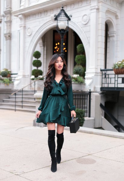 Black V-neck blouse with ruffles, matching skater skirt and flat over-the-knee boots