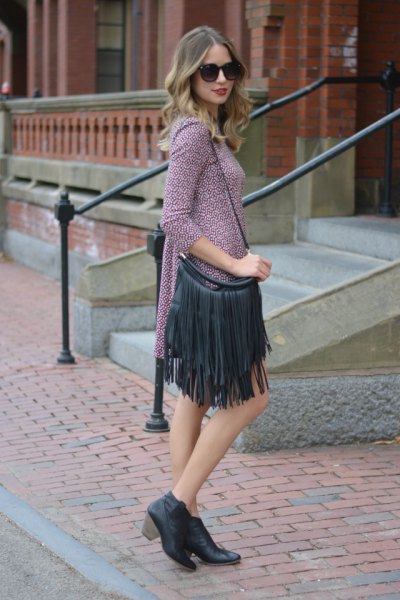 gray knitted mini dress with three quarter sleeves and black fringed leather wallet