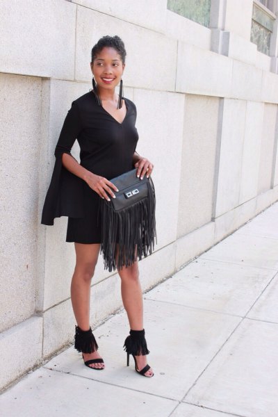 black sheath dress with bell sleeves and leather fringed wallet