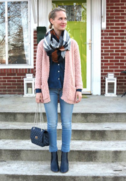 light gray fuzzy cardigan with blue jeans and leather boots