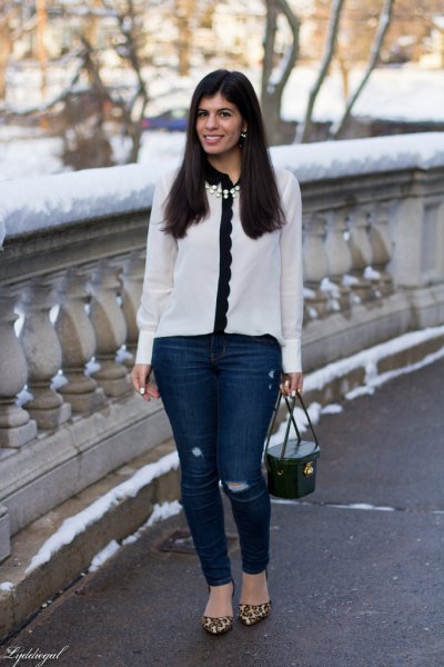white and black scalloped chiffon shirt with dark blue skinny jeans