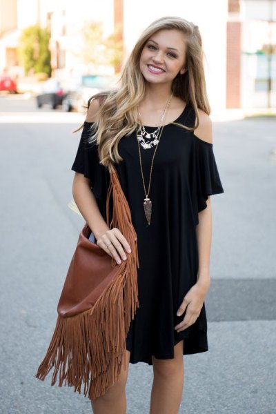 black cold shoulder mini dress with brown fringed bag