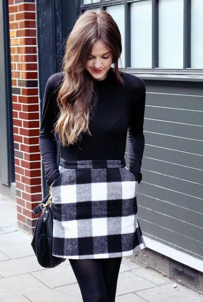 black long-sleeved t-shirt with gray and white checked wool mini skirt with pockets