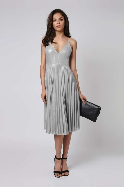 gray midi pleated dress with a deep V-neckline and black open toe heels