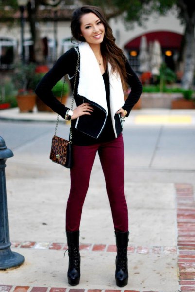 black and white shearling vest with brown skinny jeans and mid-calf boots