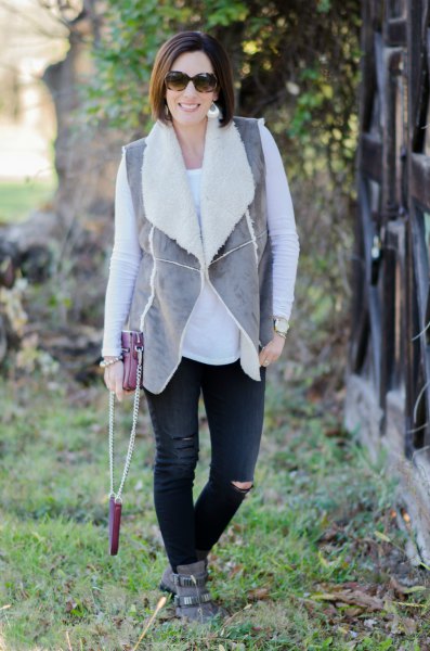 gray vest with black jeans and suede boots