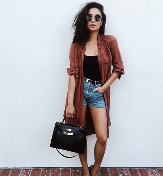 green long trench coat with black waistcoat and high-waisted denim shorts
