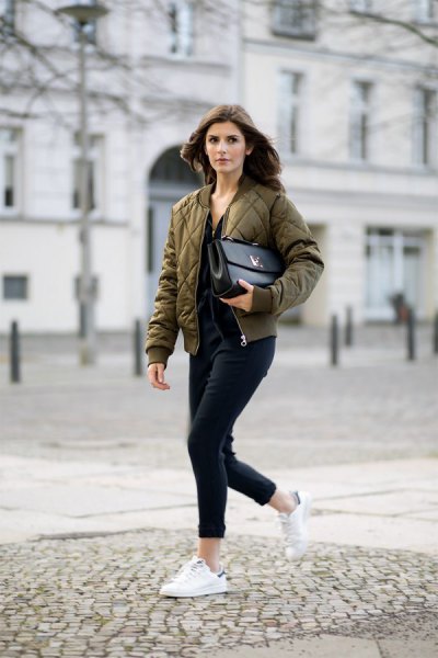green quilted pilot jacket with black jeans and white sneakers