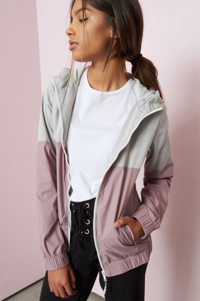 white and light gray color block Nike windbreaker jacket with black lace-up jeans