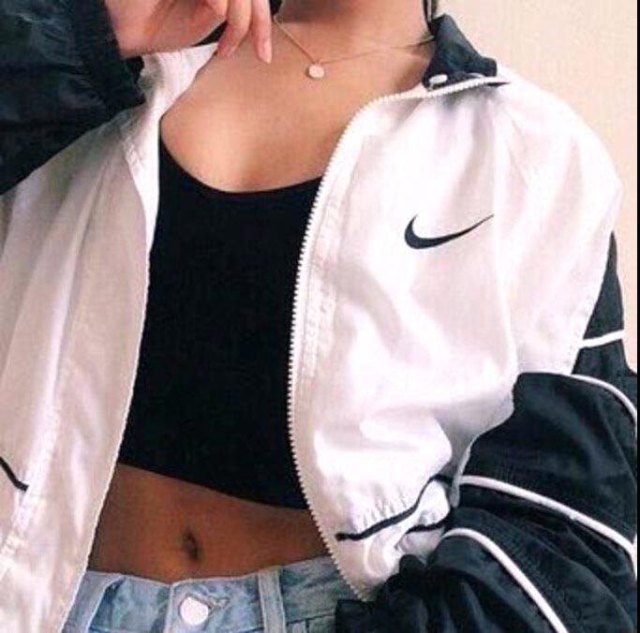 white oversized windbreaker with black cropped tank top and jean shorts