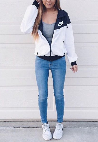 white windbreaker with gray fitted tank top and blue skinny jeans