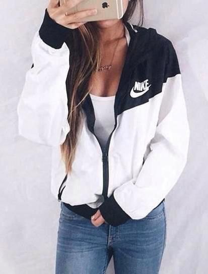 white and black Nike Windbreaker with a plunging tank top and jeans