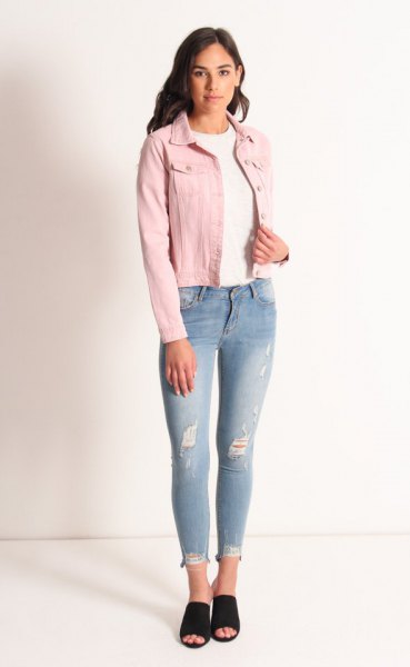 Rouge denim jacket worn with a white crew-neck sweater and light blue jeans