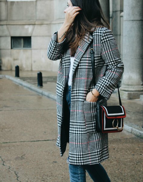 Black and white checked coat with white top and blue jeans