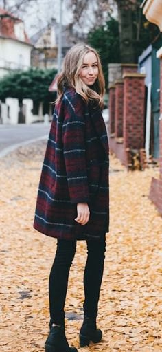 Dark blue and red plaid coat with black skinny jeans and boots