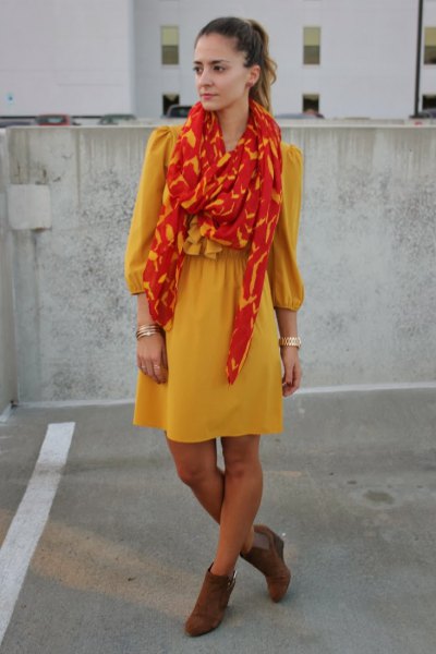 yellow flared mini dress with orange and gold scarf