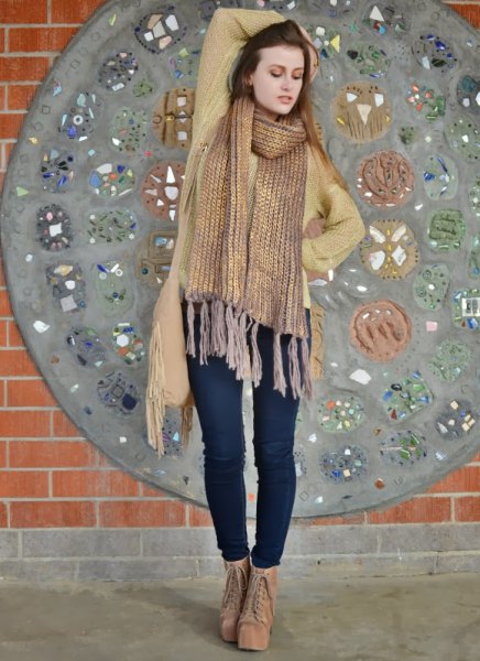 golden scarf with fringes, green cardigan and dark blue skinny jeans