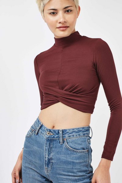 green long-sleeved mock-neck crop top and blue jeans