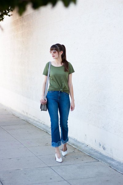 green knotted t-shirt with flared jeans with fringed hem