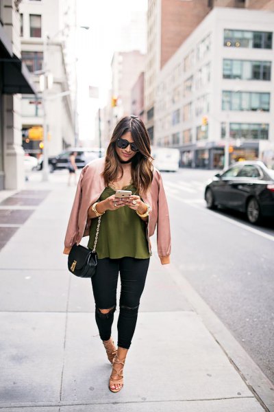 rose gold jacket with green vest top and black jeans