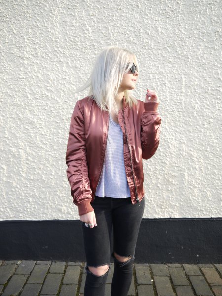 rose gold bomber jacket with striped t-shirt and black jeans