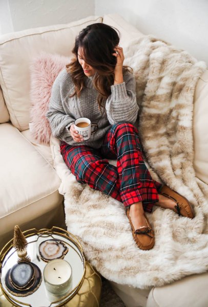 gray knit sweater with red and blue checked pajama bottoms
