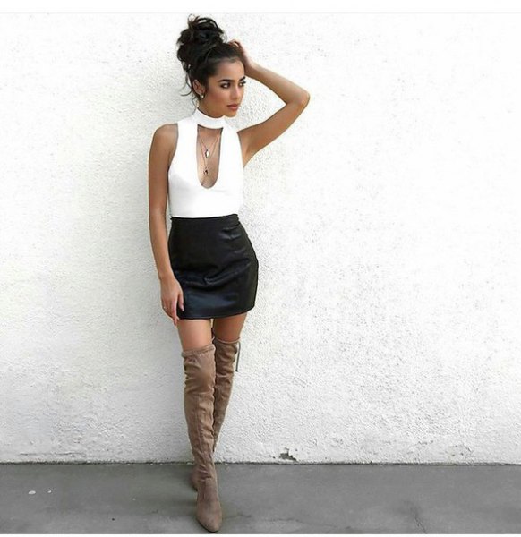 white low-cut sleeveless top with choker neckline and black mini skirt