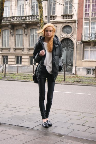black down jacket with white sweater and leather pants