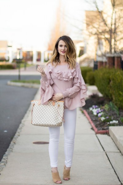 Blush pink ruffle sleeves and neck shirt with white skinny jeans