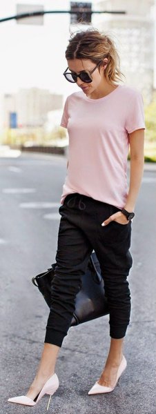 Light pink t-shirt with black sweatpants and white high heels
